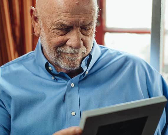 Elderly Man Looking at Picture