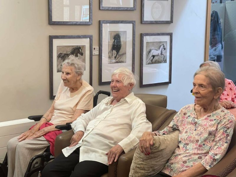 Residents Sat in Armchairs Laughing