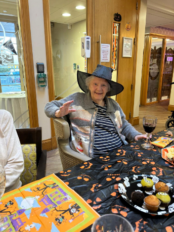 Residents, staff, and visitors dressed in creative Halloween costumes enjoying the party 