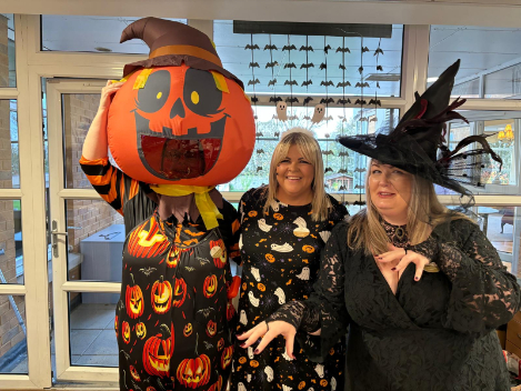 Residents, staff, and visitors dressed in creative Halloween costumes enjoying the party 